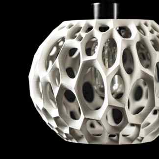 Intricate geometric 3D-printed pendant with honeycomb pattern and metallic finish, modern jewelry design.