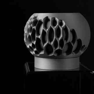 Detailed black and white image of a 3D-printed honeycomb structure showcasing precision and craftsmanship.