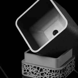 A black and white close-up image of the VORISQUARE 3D-printed planter showcasing its geometric design.