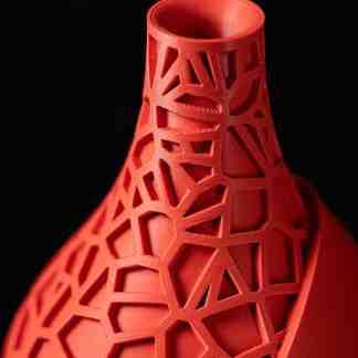 Highly detailed 3D printed geometric lattice vase in vibrant red, showcasing complex design.