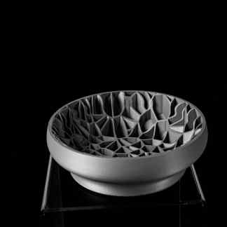 Detailed 3D-printed bowl with complex lattice design showcasing advanced additive manufacturing technology.