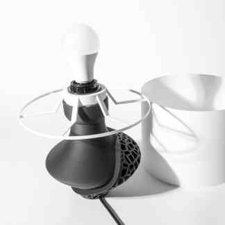 Highly detailed 3D printed drone with sleek black and white components, showcasing innovative lightweight structure.