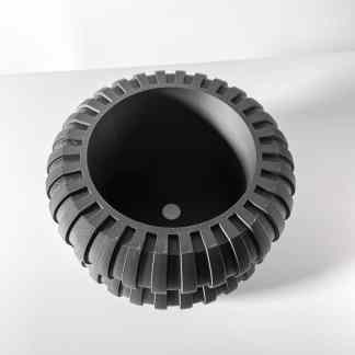 Close-up of a black 3D-printed gear showcasing detailed teeth and smooth finish for industrial applications.