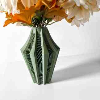 A contemporary green 3D-printed vase with layered geometric design holding artificial flowers.