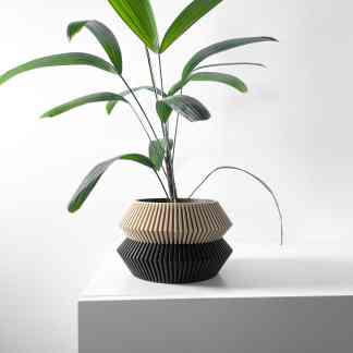 A stylish 3D printed planter featuring textured geometric patterns, ideal for indoor plant displays.