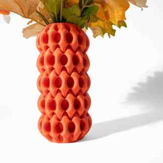 Colorful geometric 3D printed vase with floral arrangement, modern home decor piece.