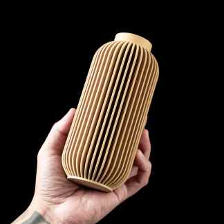 High-quality 3D-printed beige vase with intricate ribbed design for contemporary interior design.