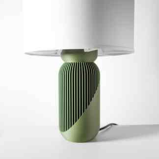 Stylish green table lamp with tiered design and unique slatted base, ideal for modern interior lighting.