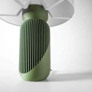 Green 3D-printed object with detailed ventilation pattern highlighting advanced digital manufacturing.