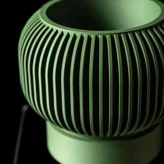 High-resolution close-up of green 3D printed mesh lamp showcasing intricate design and modern aesthetic.