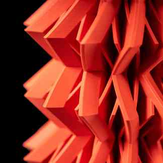 High-resolution image showcasing vibrant red 3D printed art sculpture with intricate geometric patterns.