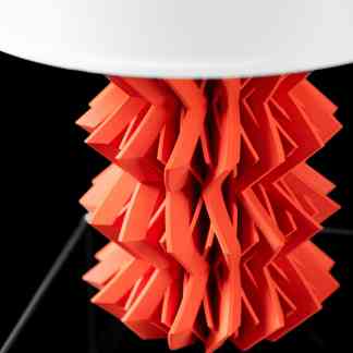 High-resolution close-up of 3D printed orange geometric structure on a black background.