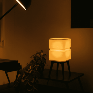 Elegant warm white LED table lamp with minimalist design on black stand.