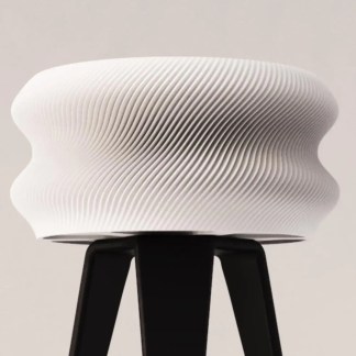 A modern white 3D-printed stool featuring intricate layered patterns, showcasing innovative design and 3D printing technology.