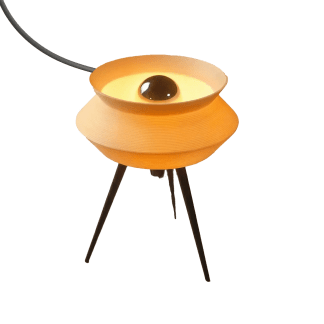 A contemporary Gorshok table lamp featuring an orange body and tripod black legs, perfect for modern interiors.