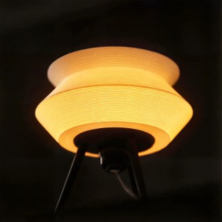 A sleek wooden Gorshok table lamp with warm yellow LED light, ideal for modern home or office settings.
