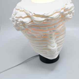 Unique modern table lamp with layered textured white finish, energy-efficient LED light.