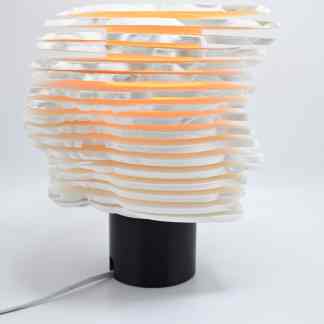 Modern decorative table lamp with layered, textured design, ideal for contemporary home decor.
