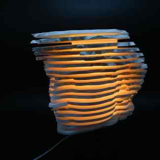 Illuminated modern 3D-rendered lamp with layered, abstract face profile design. Unique home decor lighting piece.