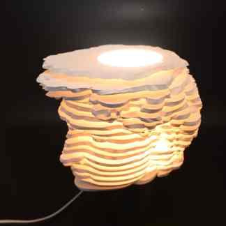 Stylish 3D printed layered lamp with ambient warm light, perfect for modern interior decoration.