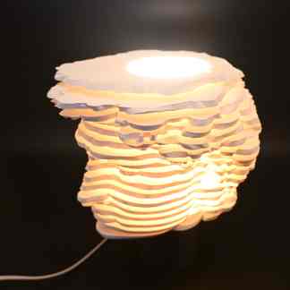 Beautiful layered paper shell lamp with warm light, handcrafted 3D design, perfect for ambient home lighting.