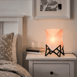 Unique origami-inspired 3D table lamp with warm glow for cozy bedroom decor.