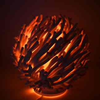 Shaped 3D printed lamp with warm glow for modern decor.